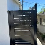 Modern black aluminum fence gate with horizontal slats. Fence Company Handy Maestro