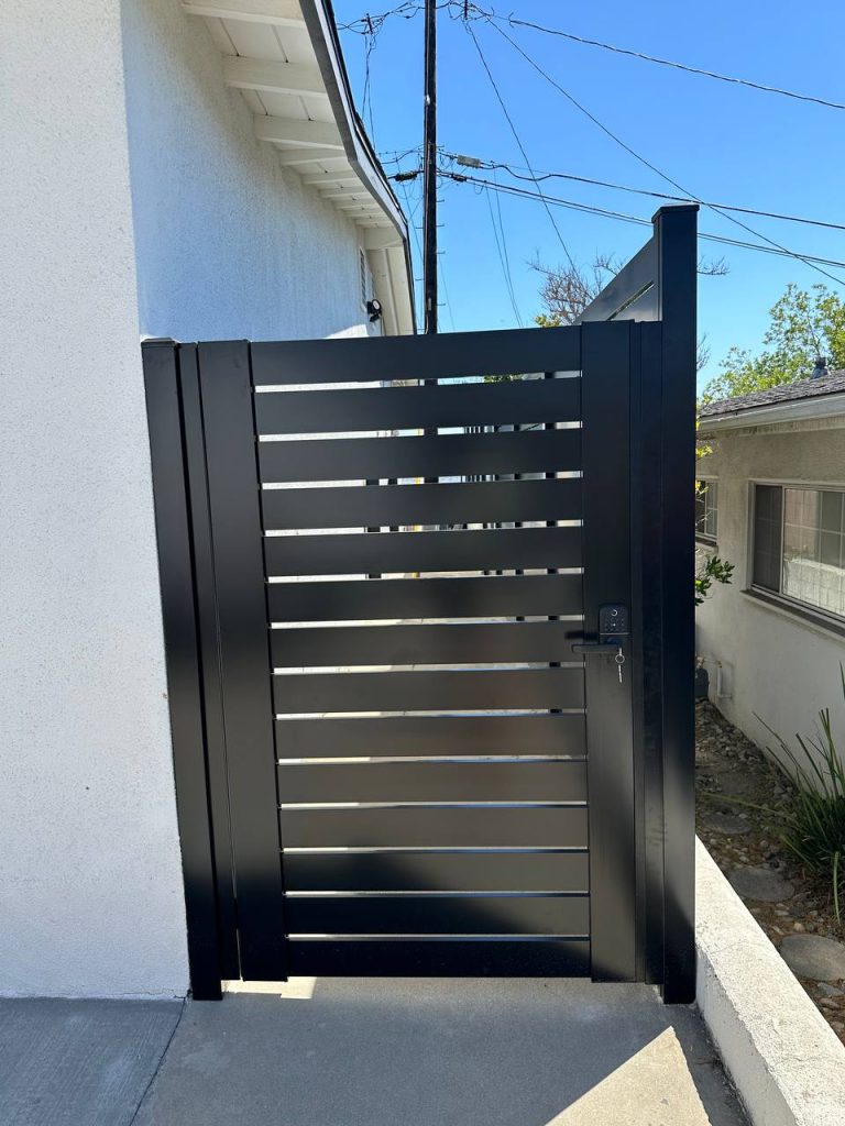 Modern black aluminum fence gate with horizontal slats. Fence Company Handy Maestro